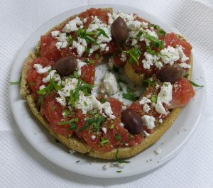 Traditional Cretan Food- Dakos with tomato, olives and mizhthra